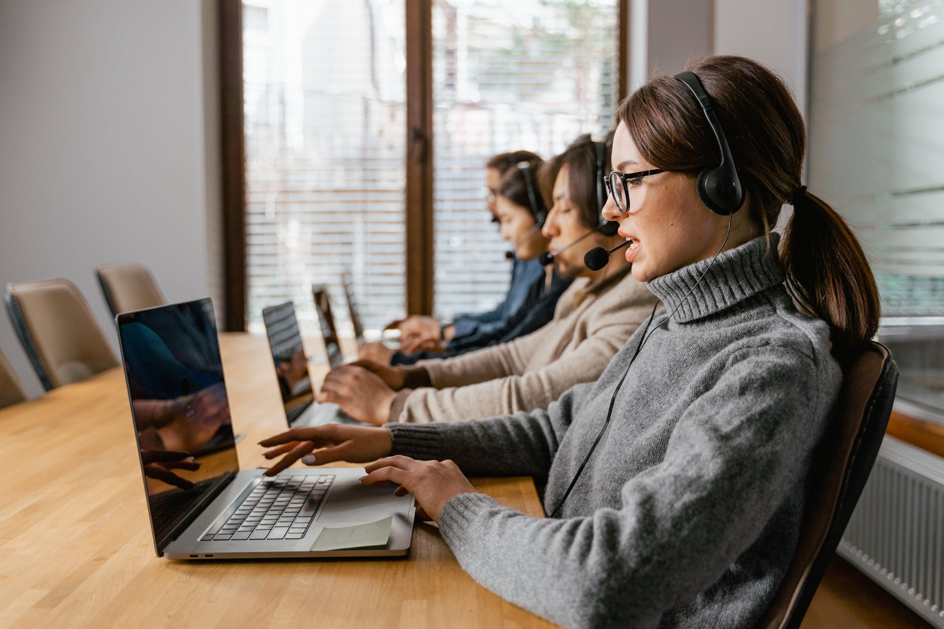 a woman in gray sweater attending a call