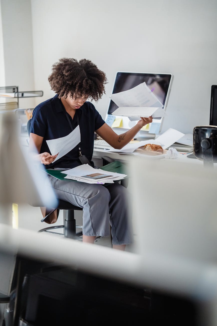 woman in an office looking through documents on her lap